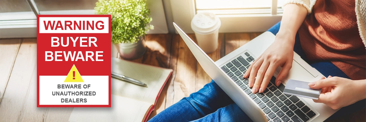 Person using a laptop with a 'Warning Buyer Beware' sign in the corner.